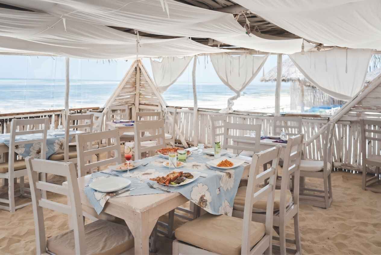 The beach restaurant at Exploreans Watamu — a thatched gazebo set on the sand of Mayungu Bay.