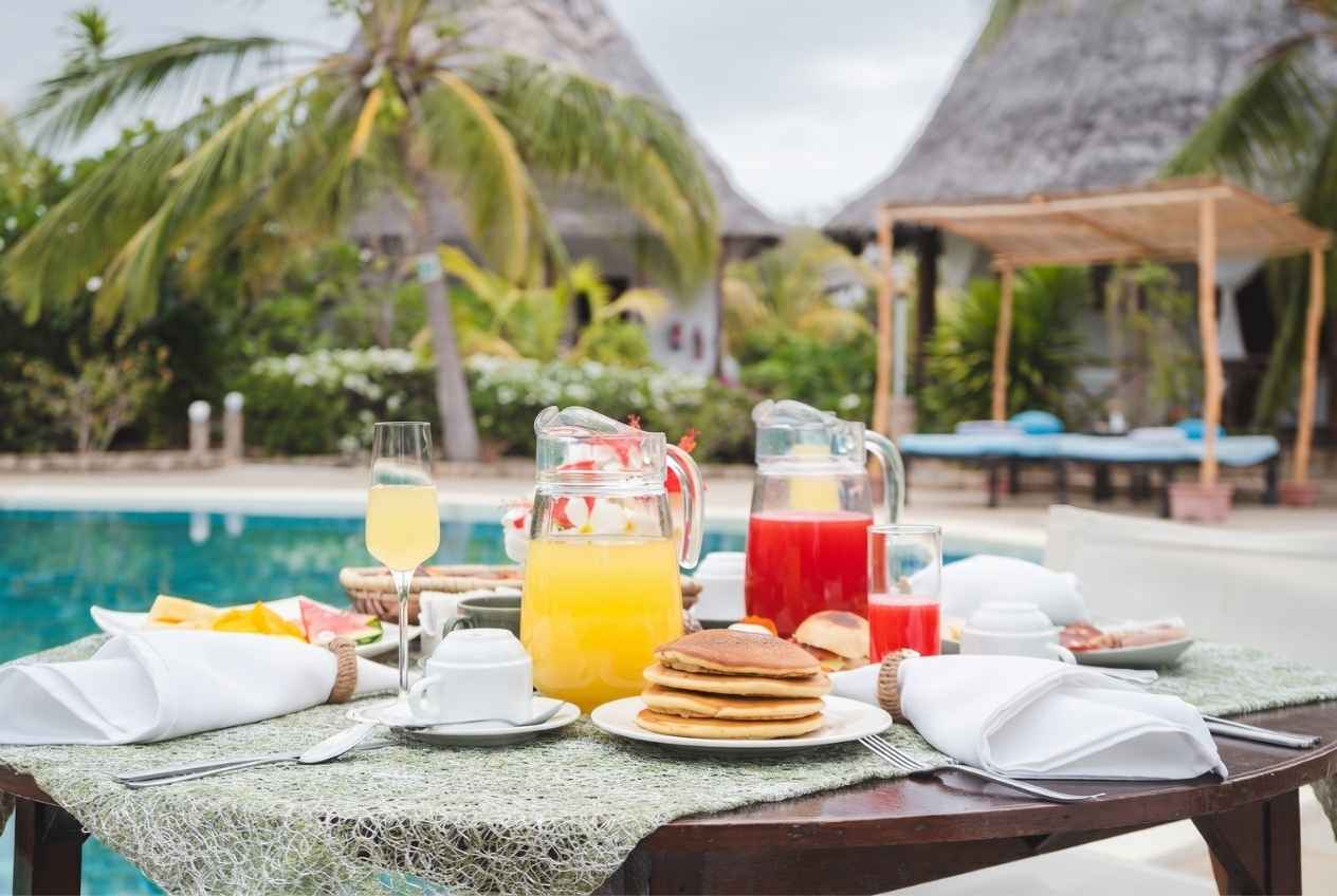 Breakfast at Exploreans Watamu's main restaurant — dining by the pool.